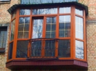 Остекление балкона окнами из сосны